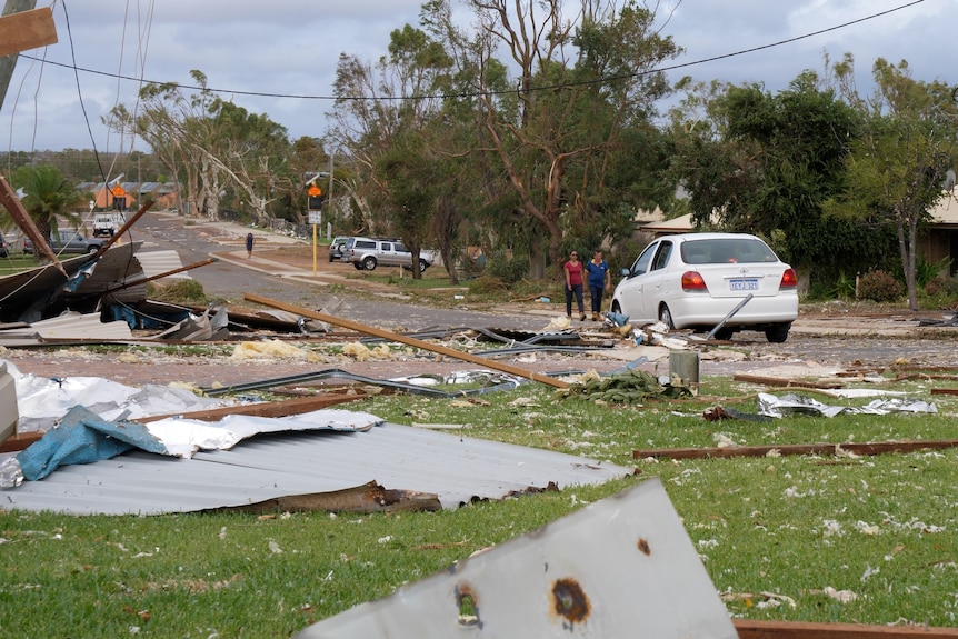 A street in a regional town strewn with debris after a cyclone.