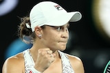 An Australian female tennis player pumps her fist.