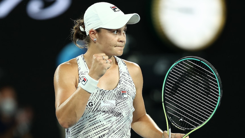 An Australian female tennis player pumps her fist.