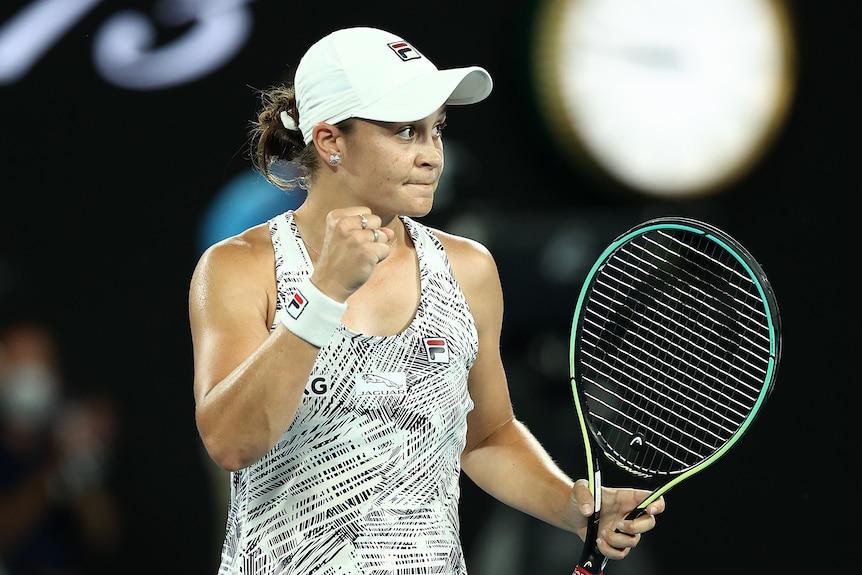 An Australian female tennis player pumps her fist.