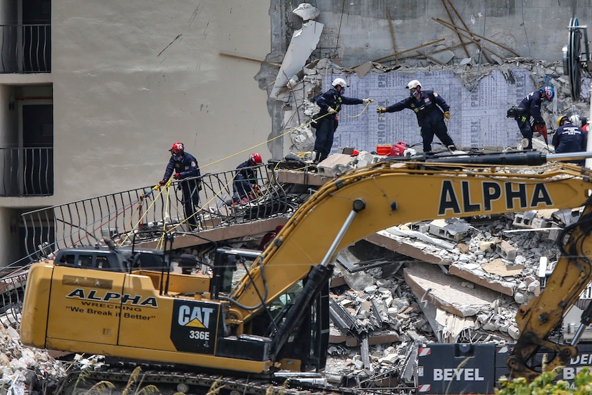 A South Florida Urban Search and Rescue team looks for survivors at the 12-story building