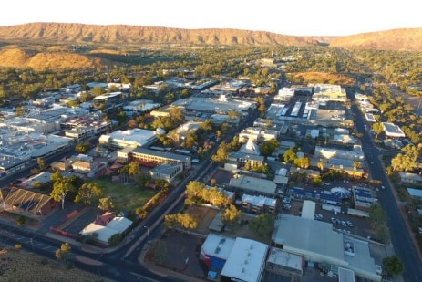 Alice Springs town viewed from above with ranges in the distance.