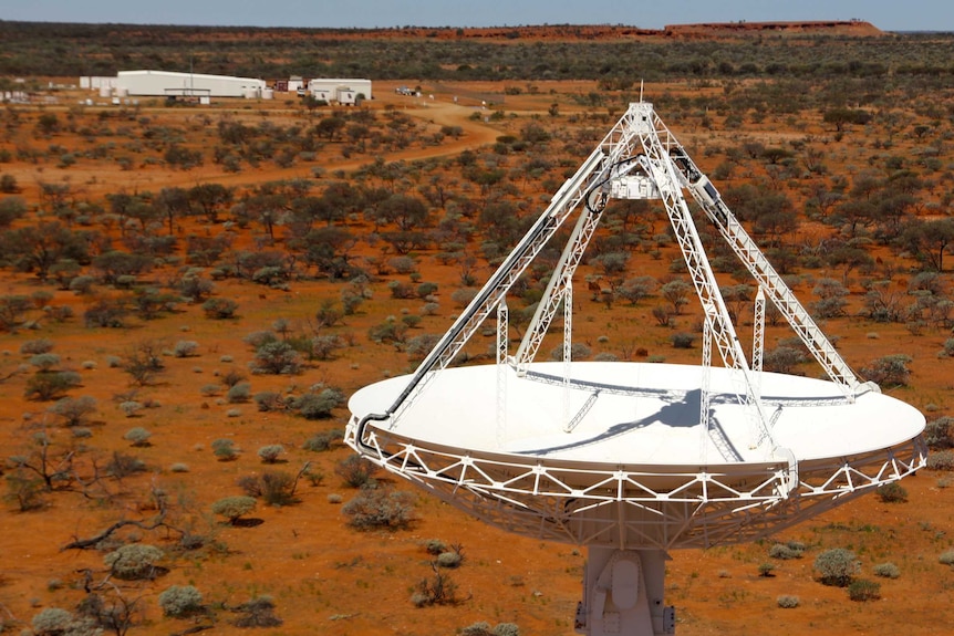 A drone image shows large white antennas built on the red earth of the Murchison.