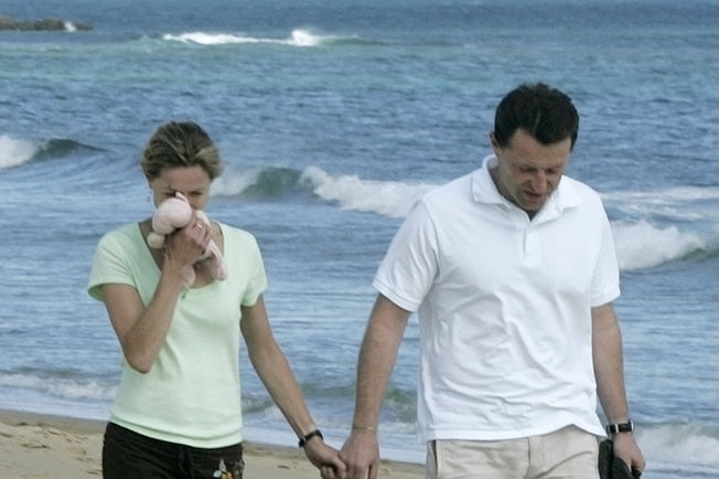 Kate and Gerry McCann, parents of Madeleine McCann, walk on the Luz beach.