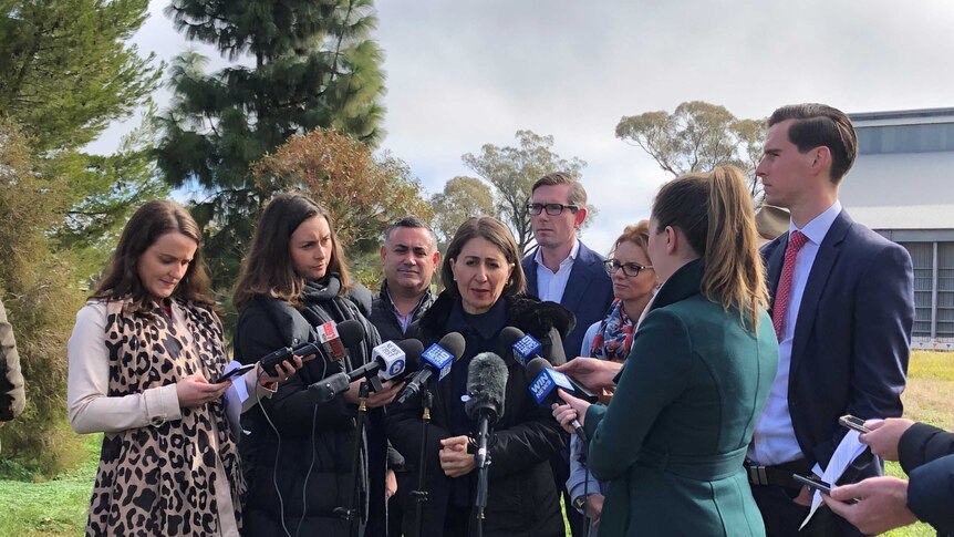 NSW Premier Gladys Berejiklian surrounded by journalists