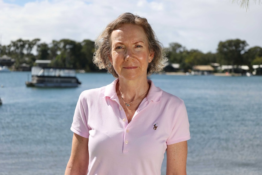 Michelle Snape stands in front of a river.