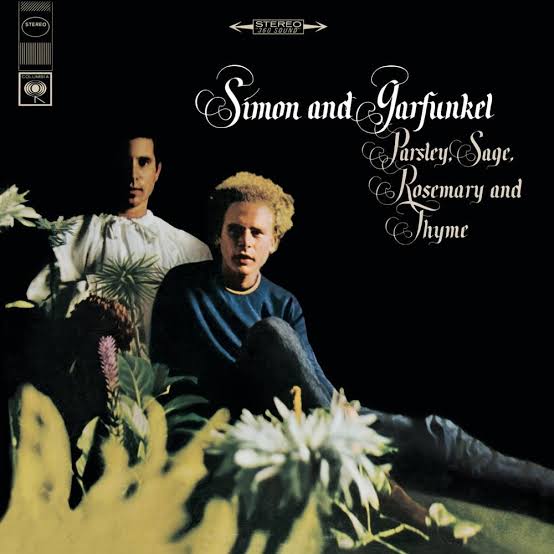 The cover of Parsley, Sage, Rosemary & Thyme features Simon & Garfunkel sitting in a dark room with flowers