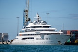 A large white superyacht berthed at Queens Wharf in Lautoka, Fiji.