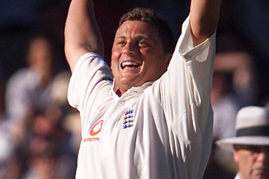 Darren Gough smiles with his arms in the air