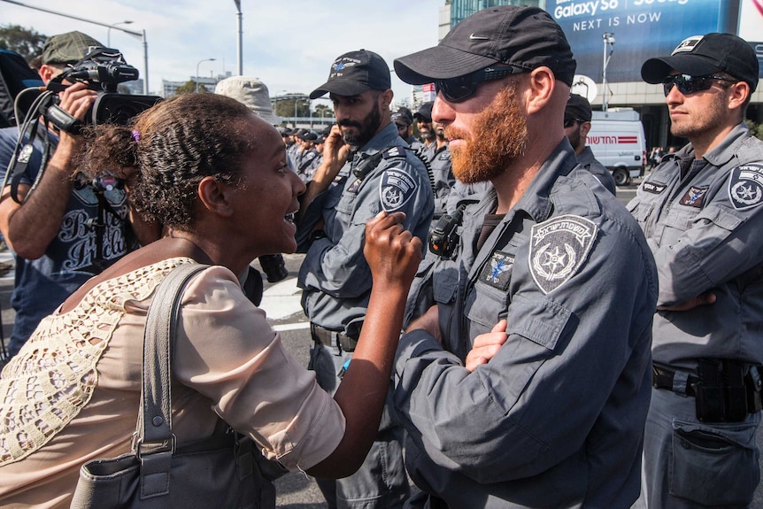 A protester confronts police during an anti-racism rally in Tel Aviv
