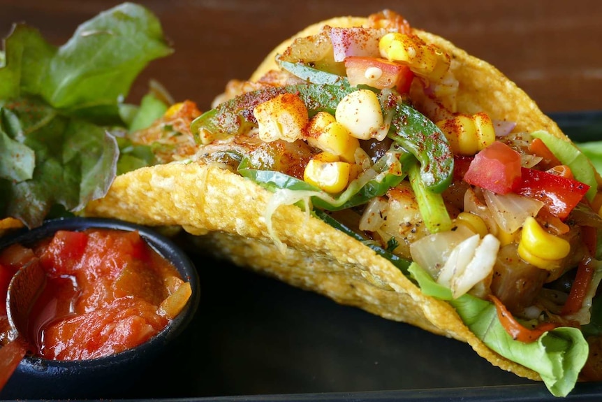 A taco full of vegetables.