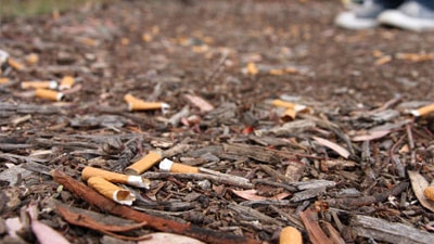 Cigarette butts litter the ground