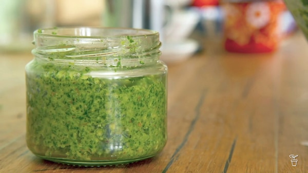 Jar filled with pesto.