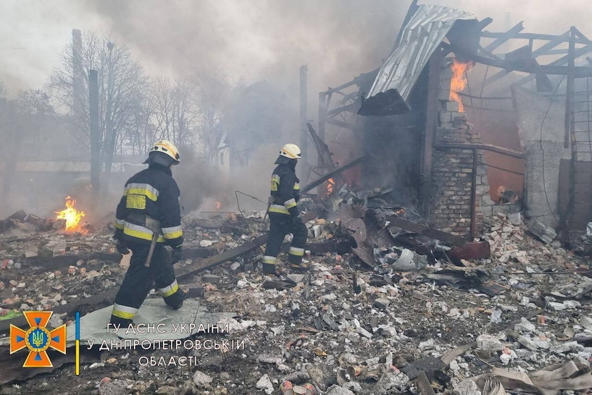 Rescuers work among remains of buildings damaged by an airstrike.