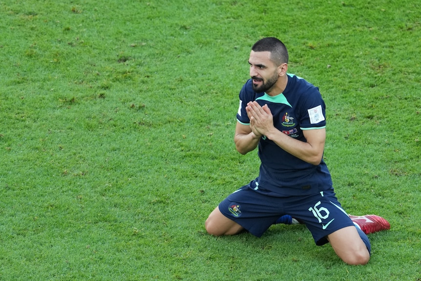 Behich on his knees smiling