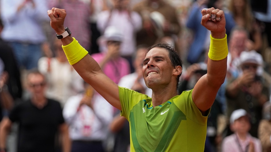 Rafael Nadal raises his fists triumphantly.