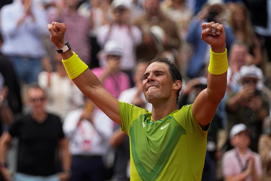 Rafael Nadal raises his fists triumphantly.