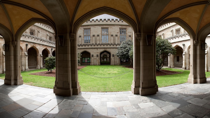 lawn quadrangle surrounded by sandstone cloisters
