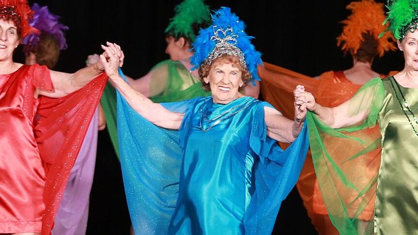 Lorraine Kaemphel wearing a colourful blue dress dancing at an estedfodd