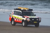 An ambulance on Park Beach driving along the sand