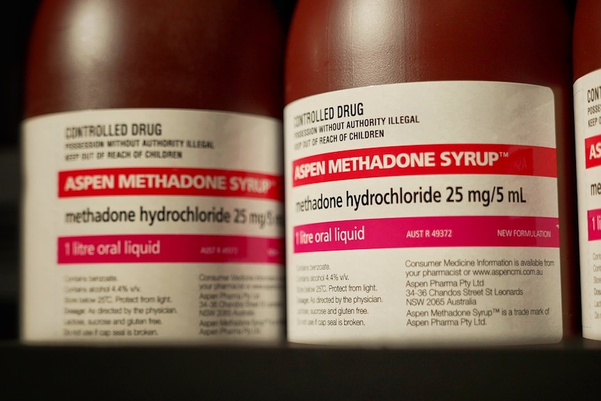 A close-up of brown Aspen Methadone Syrup bottles