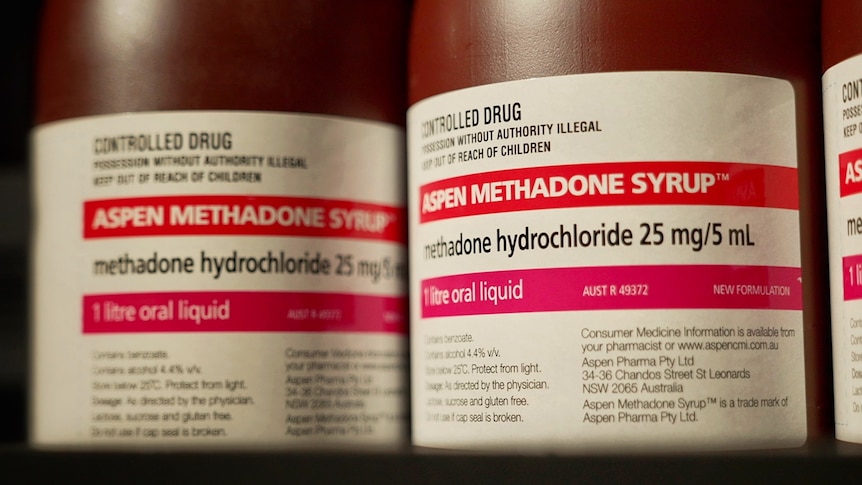 A close-up of brown Aspen Methadone Syrup bottles