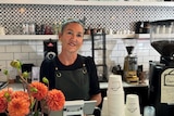 a woman behind a cafe bar