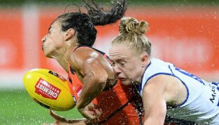 Amanda Farrugia of the Giants is tackled by Emma Humphries of the Kangaroos.