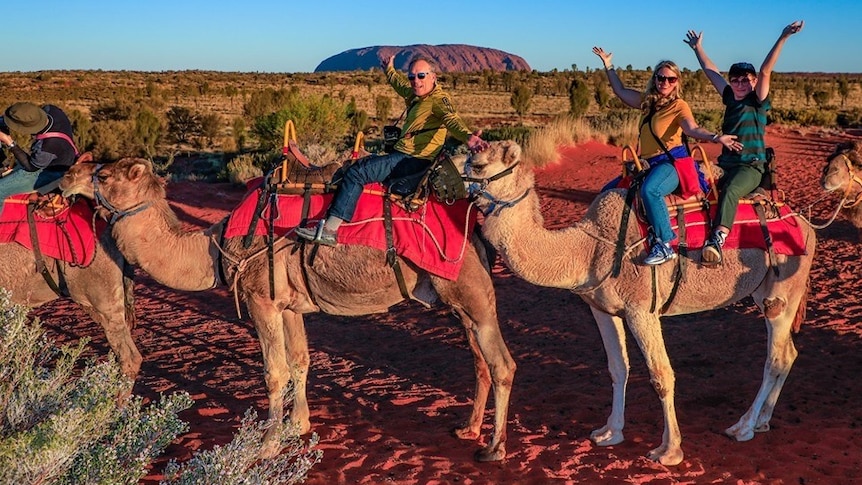 US tourist Mary Shrader at Uluru riding a camel.