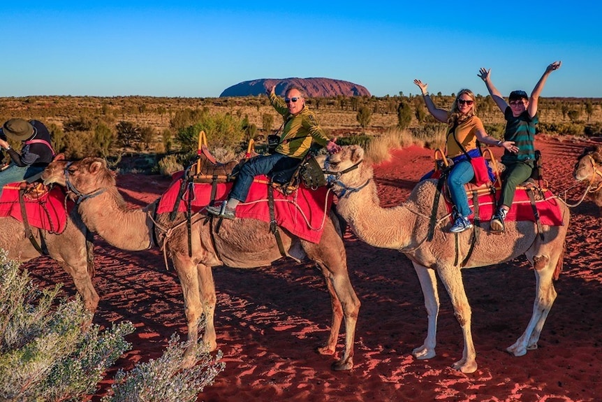 US tourist Mary Shrader at Uluru riding a camel.