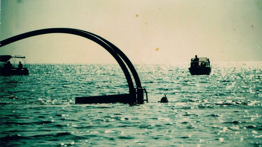 Two large tubes protruding out of the water.