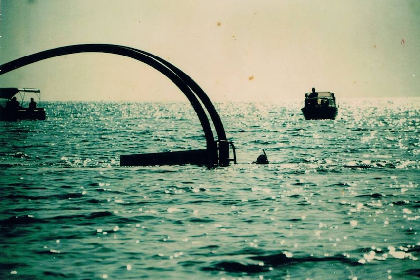 Two large tubes protruding out of the water.