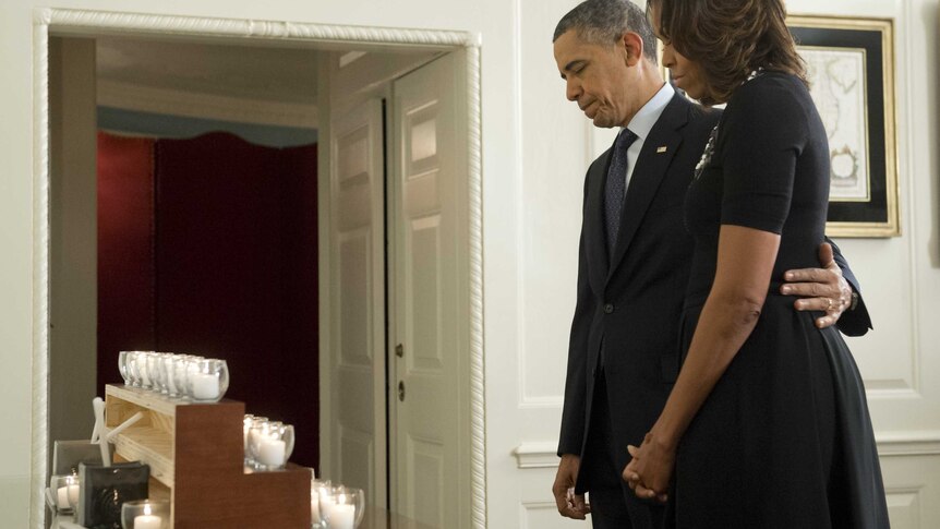 The Obamas lit one candle for each of the victims.