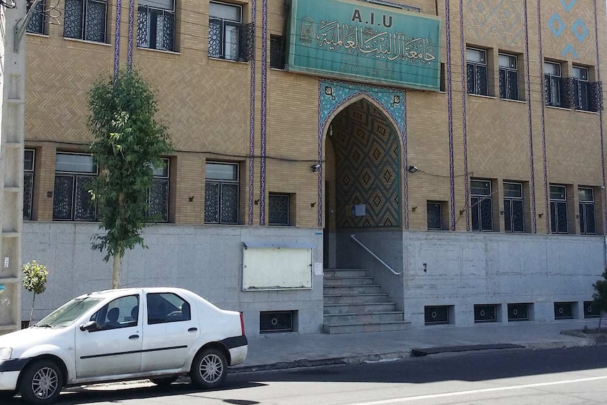 A brick building with a sign reading: AIU.