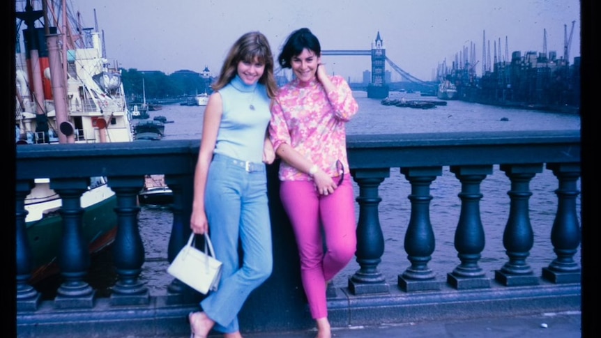 Two young women stand in front of London Bridge in the 1960s.