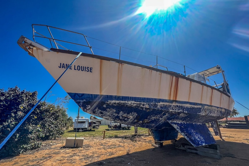 A boat sits in disrepair in the yard at Carnarvon's yacht club