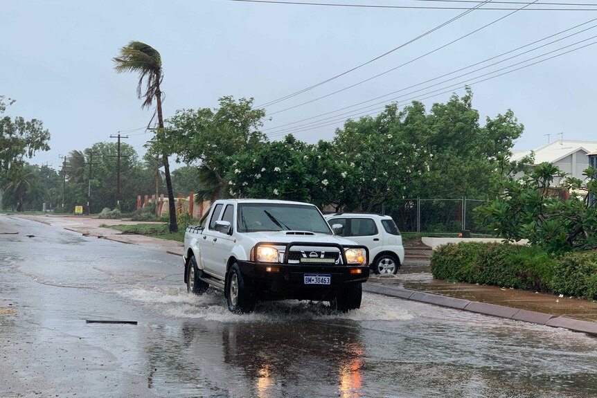 car moving through flooded street