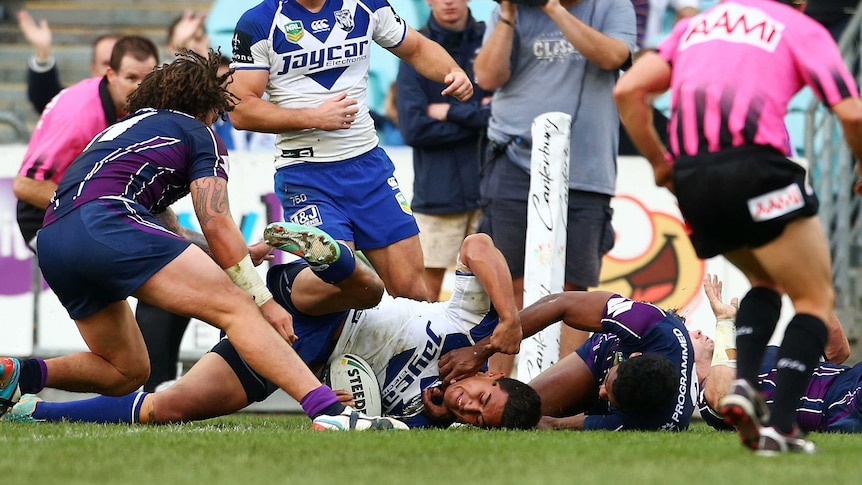 Tim Lafai scores for the Bulldogs against the Storm at the Olympic stadium.