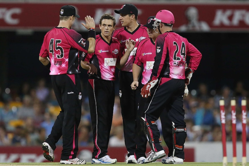 The Sixers celebrate the wicket of Ben Cutting