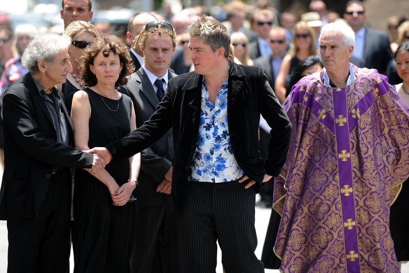 Luke Waterlow (centre) shakes hands with his father's friend, Ross Mellick