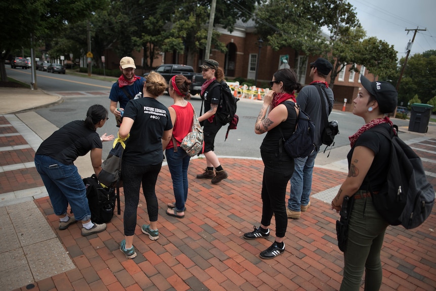 Redneck Revolt members stand at a street corner in Charlottesville.