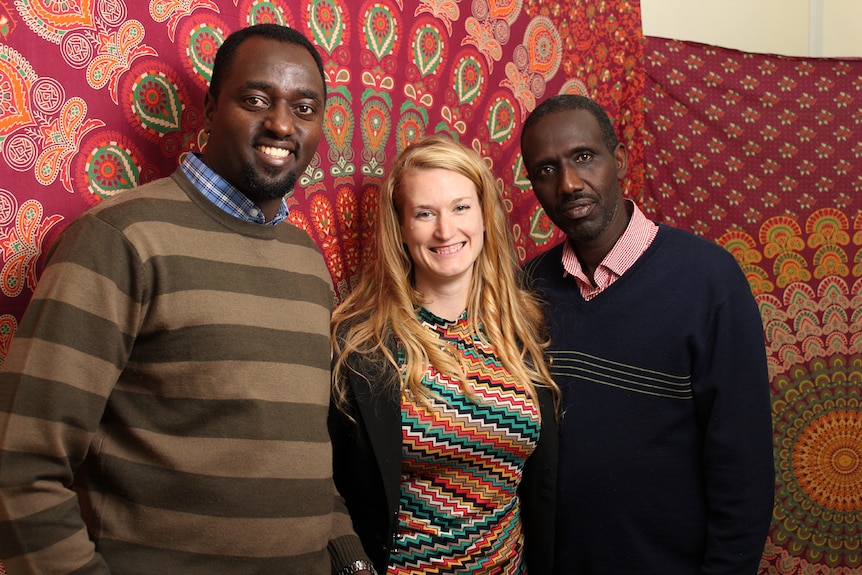 Congolese men Claude Muco and Mutebutsi Bugegeri with refugee advocate Monique Bolus.