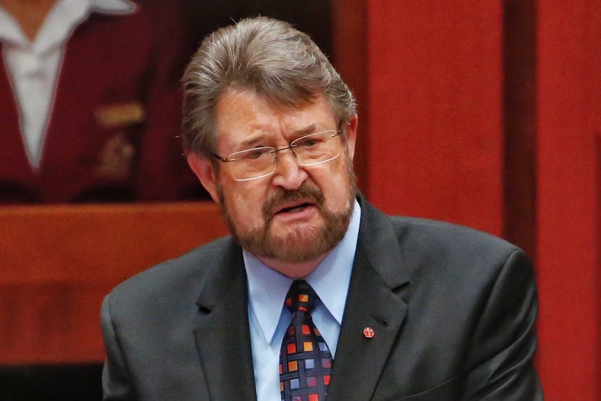 Derryn Hinch wears a colourful tie and black suit in Parliament.