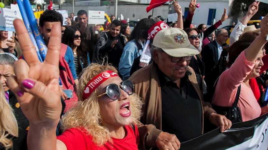 Tunisian demonstrators shout during a protest