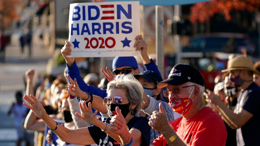 People celebrate the presidential race being called in favor of President-elect Joe Biden over President Donald Trump.