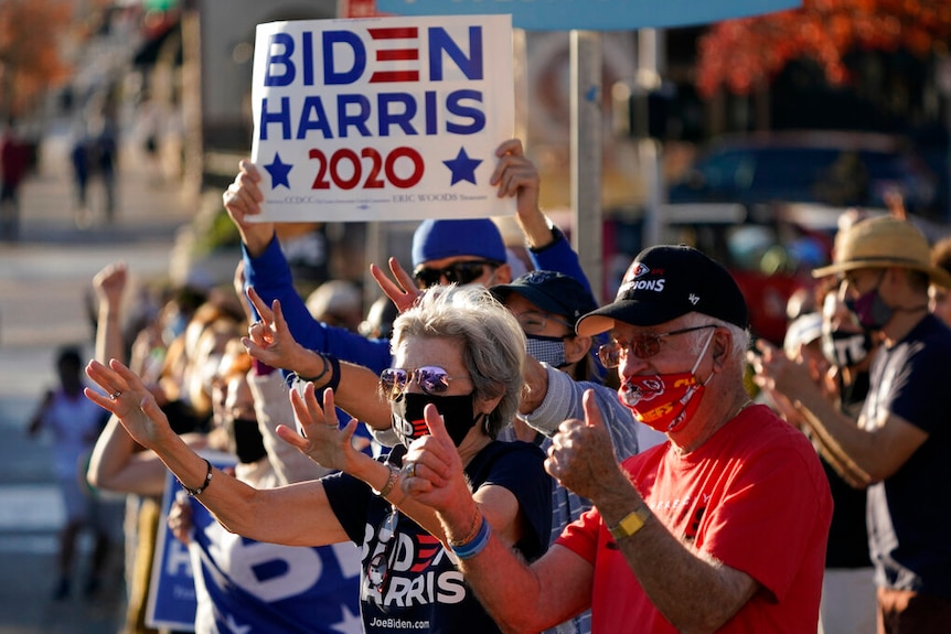 People celebrate the presidential race being called in favor of President-elect Joe Biden over President Donald Trump.