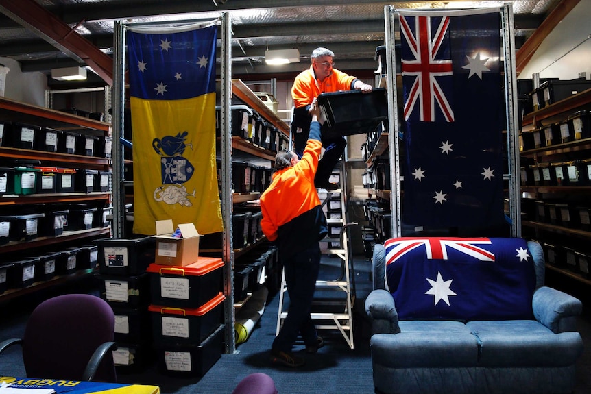 Michael and Marc move flags around the store in Fyshwick.