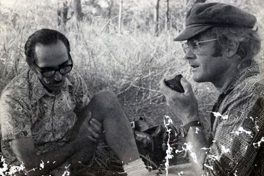 Laurentino Pires and Robert Wesley-Smith speaking into a two-way radio.