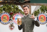 Bayern Munich player Philippe Coutinho poses with a beer.
