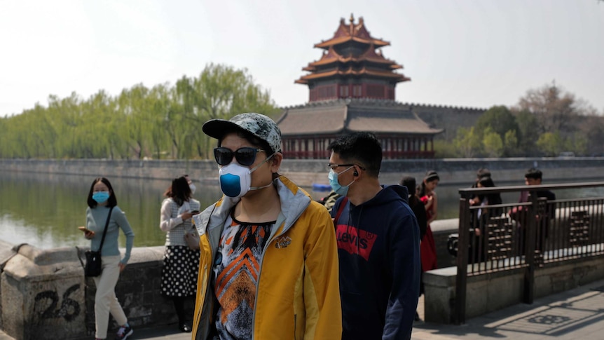 Tourists wearing protective face masks at the Forbidden City in Beijing.